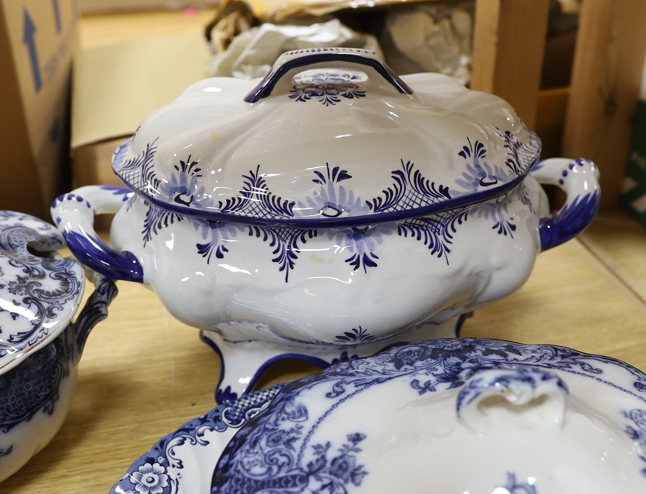Two blue and white soup tureens and two vegetable tureens and a meat dish